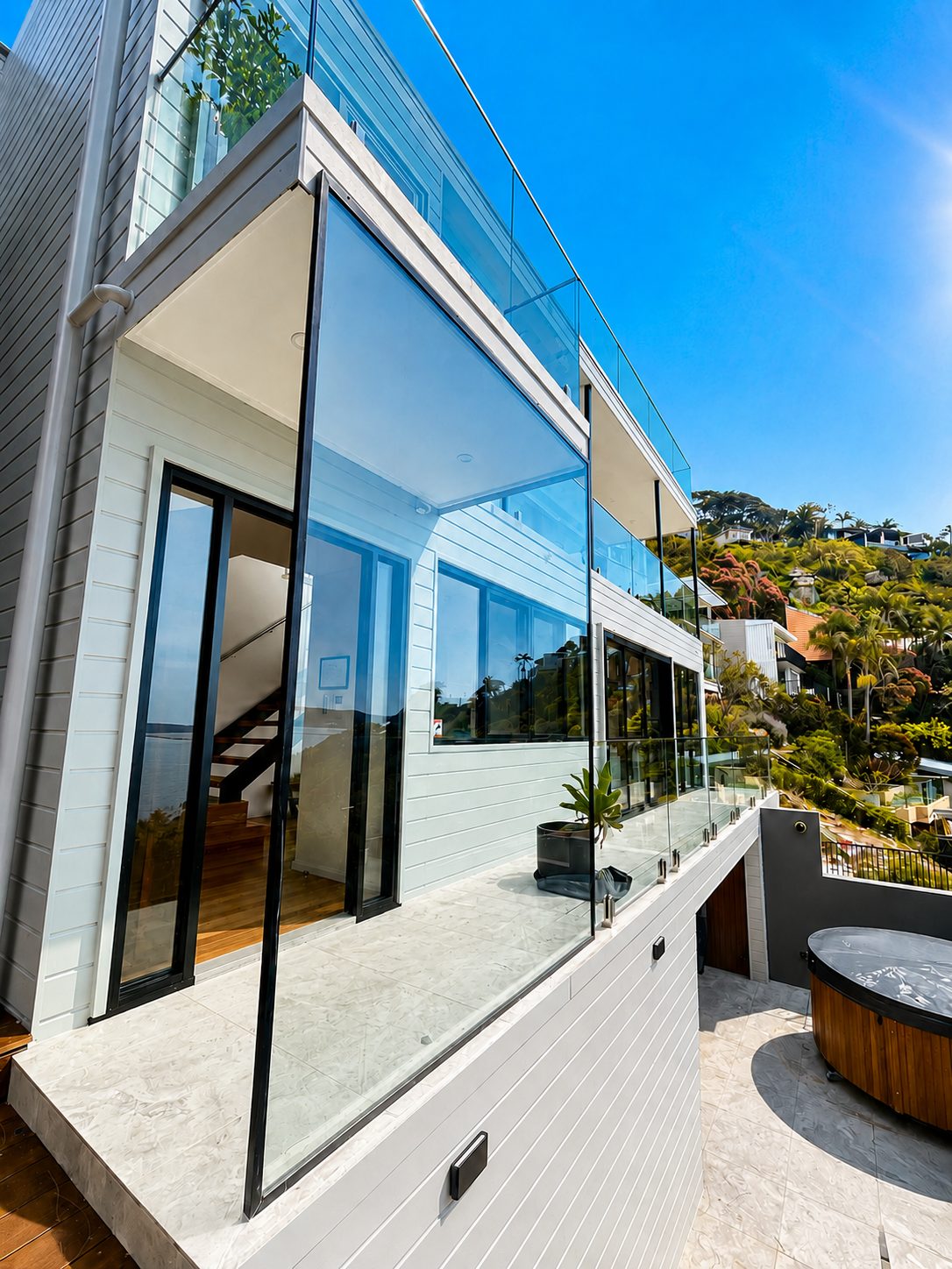 Glass balconies with a tilting weather screen - Whale Beach house - frameless glass, ocean views