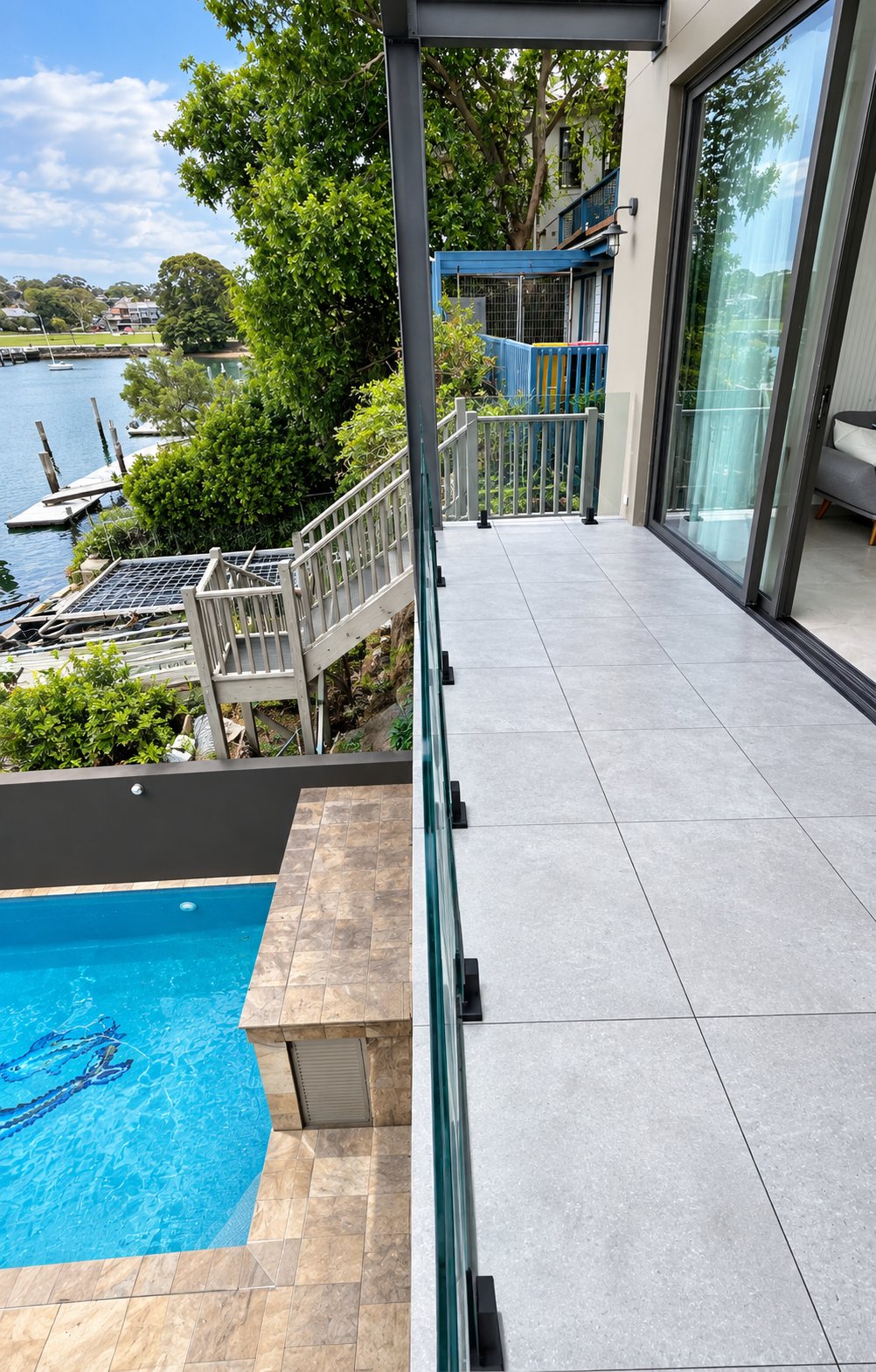 Low-profile spigots along the balcony edge above the pool - Harbourfront terrace - frameless glass, Rozelle