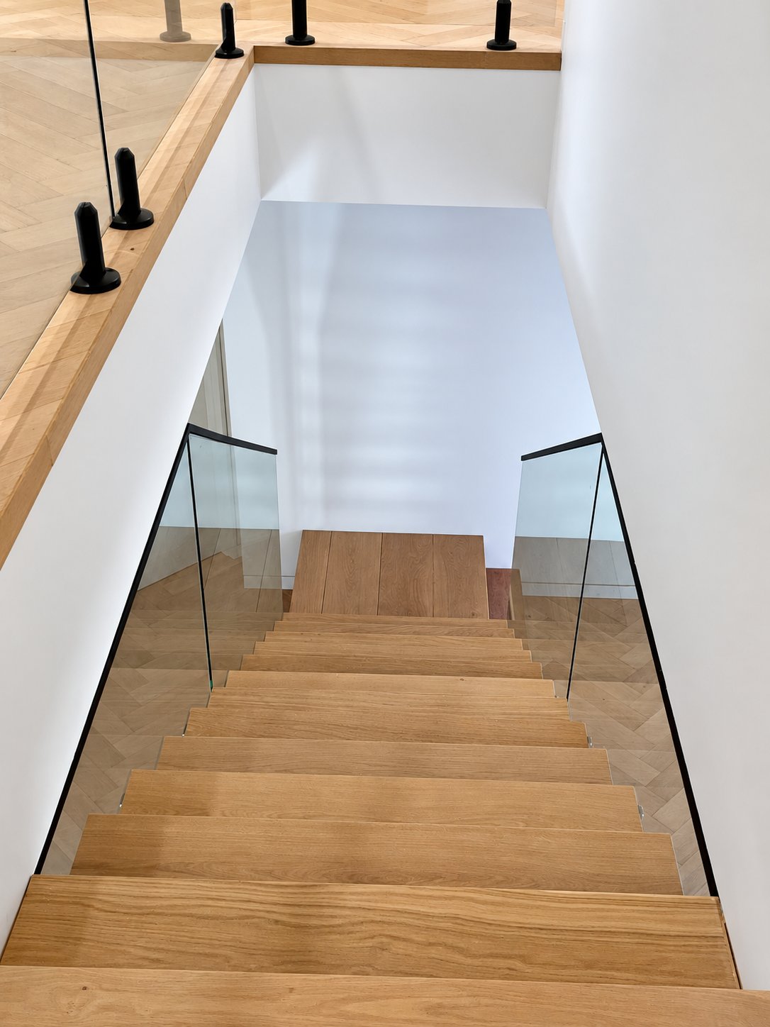 Looking down the stair - glass scribed to the treads with no gaps - New staircase glass with welded top rail - Strathfield