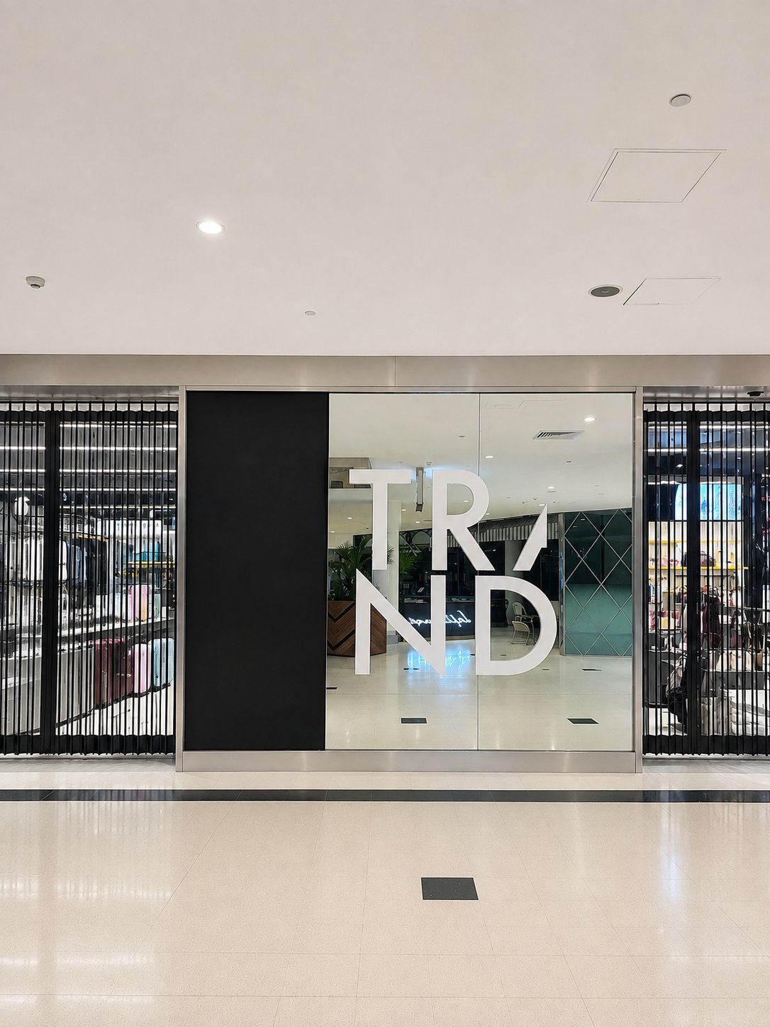 The finished shopfront - new mirror panels set behind the TRND lettering - Retail mirror replacement - Macarthur Square Shopping Centre