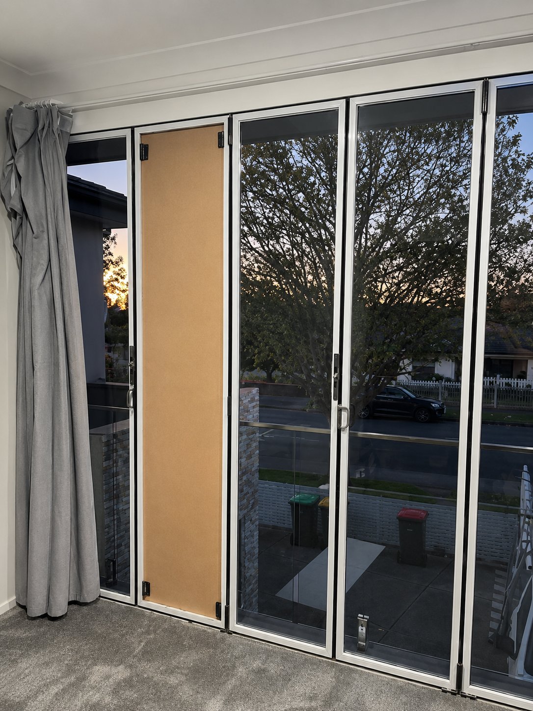 Temporary board fitted to keep the room secure while the new double glazed unit was made - Bifold door double glazed glass replacement - Lidcombe