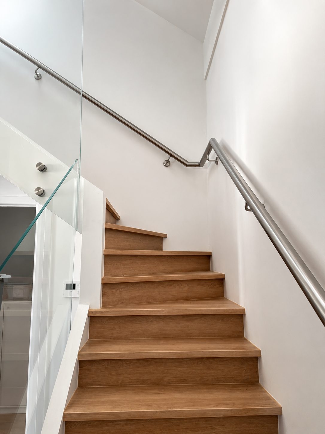 Handrail paired with a frameless glass balustrade - Curved handrail on a Sydney staircase