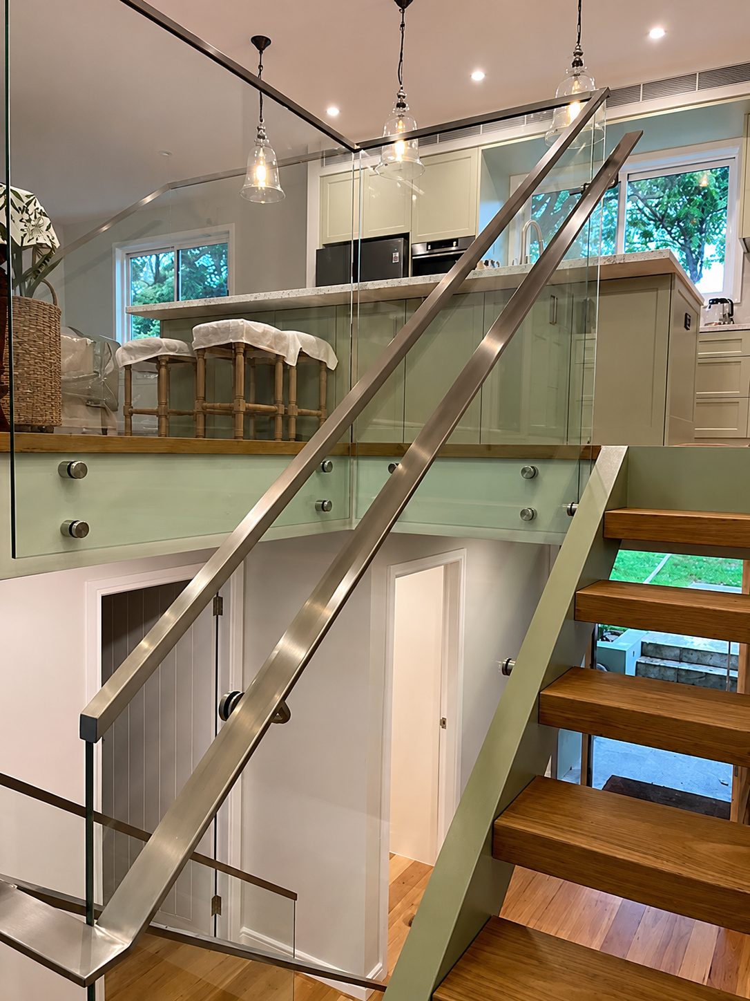 Finished handrail and glass balustrade, stair to mezzanine - Curved handrail on a Sydney staircase