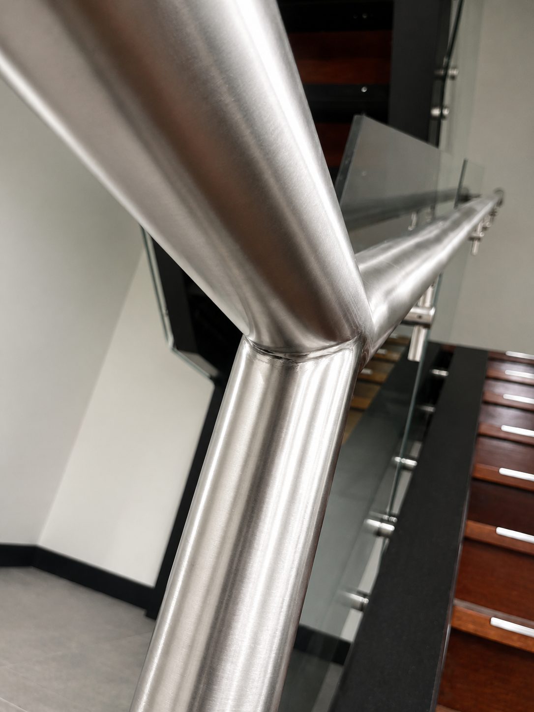 Welded joints, ground and polished to a seamless finish - Commercial stair handrails, Sydney